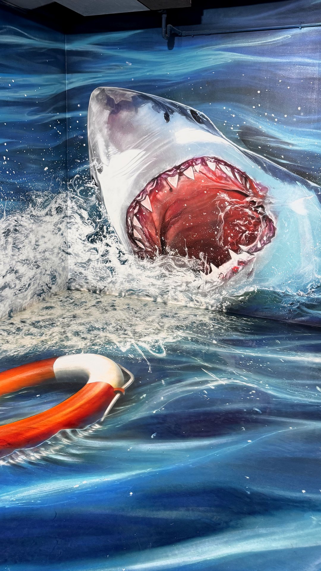 Painted great white shark leaping at a life ring inside the museum